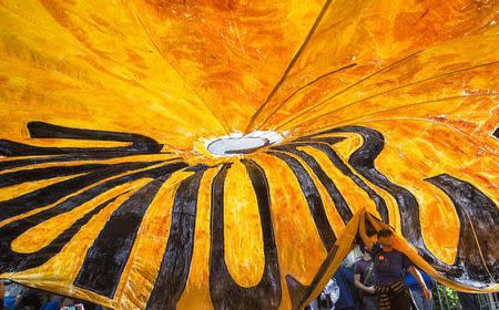 Activist Gloria Fallon, from Chicago, holds a parachute banner which reads 'Justice' while taking part in the Flood Wall Street demonstration in Lower Manhattan, New York September 22, 2014. REUTERS/Adrees Latif