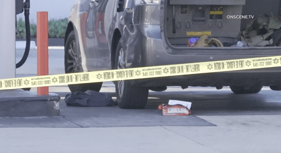 A van behind police tape at a gas station in Bellflower. The Los Angeles County Sheriff’s Department says an off-duty LAPD officer was hit by a stray bullet in what appeared to be a gang-related shooting on May 5, 2024. (OnScene.TV)