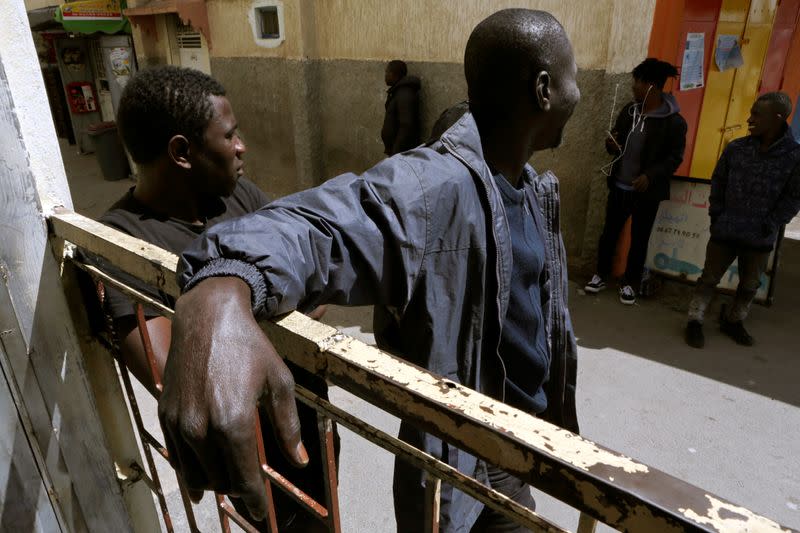 African migrants stand at Hay el Farah area on the outskirts of Rabat
