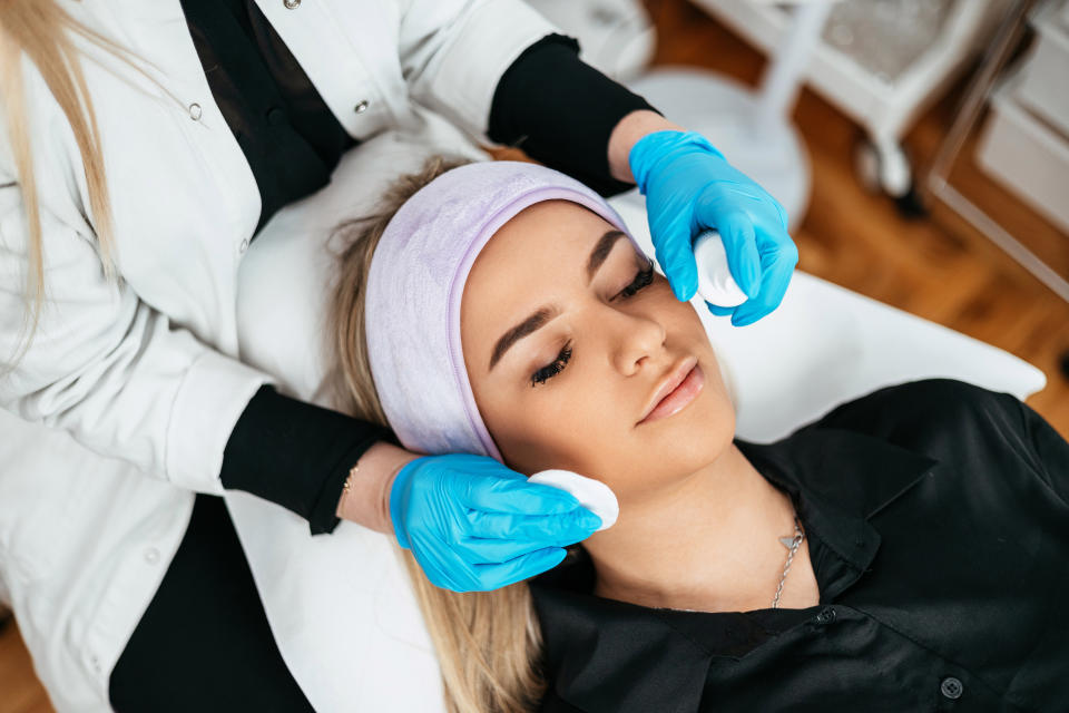 esthetician giving a client a facial