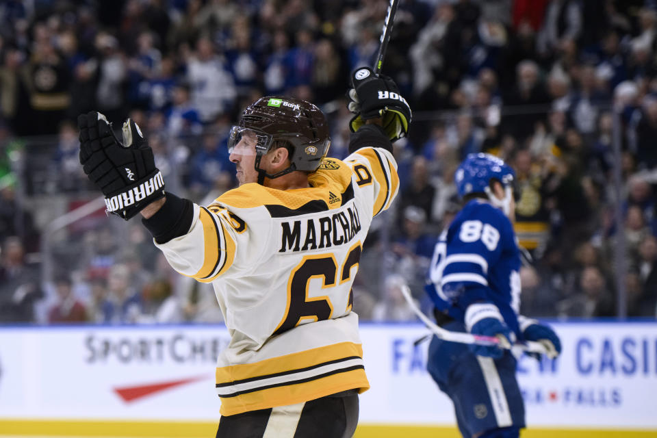 Boston Bruins left wing Brad Marchand (63) celebrates after scoring in overtime against the Toronto Maple Leafs in an NHL hockey game Saturday, Dec. 2, 2023, in Toronto. (Christopher Katsarov/The Canadian Press via AP)