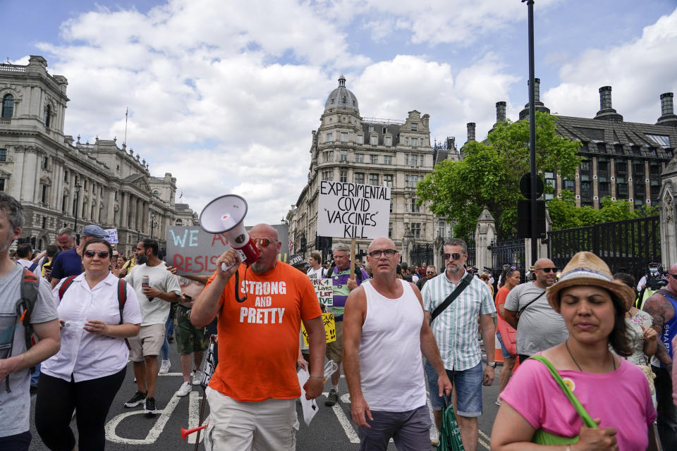 People gather outside the Palace of Westminster, to protest against the delay of the planned relaxation of lockdown measures, in London, Monday, June 14, 2021. British Prime Minister Boris Johnson is expected to confirm Monday that the next planned relaxation of coronavirus restrictions in England will be delayed as a result of the spread of the delta variant first identified in India. (AP Photo/Alberto Pezzali)