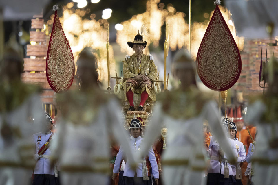 In this May 5, 2019, photo, Thailand’s King Maha Vajiralongkorn is carried on a palanquin through the streets outside the Grand Palace for the public to pay homage during the second day of his coronation ceremony in Bangkok. Vajiralongkorn was officially crowned Saturday amid the splendor of the country’s Grand Palace, taking the central role in an elaborate centuries-old royal ceremony that was last held almost seven decades ago. (AP Photo/Wason Wanichorn)