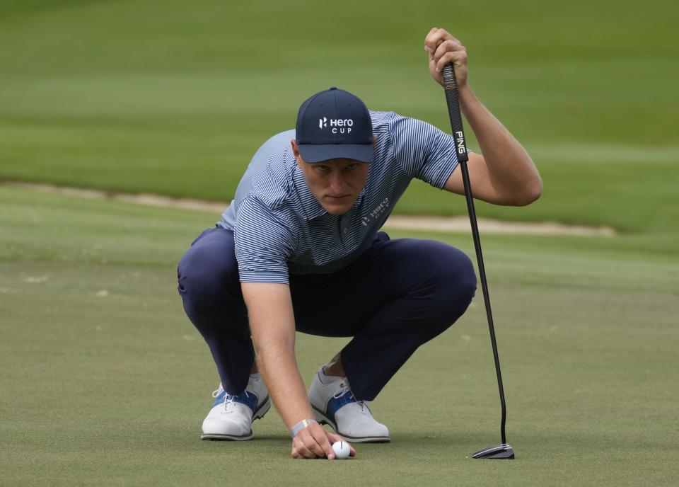 Adrian Meronk of Continental Europe prepares for a shot on the second hole, during the Fourball matches of the Hero Cup at Abu Dhabi Golf Club, in Abu Dhabi, United Arab Emirates, Friday, Jan. 13, 2023. (AP Photo/Kamran Jebreili)