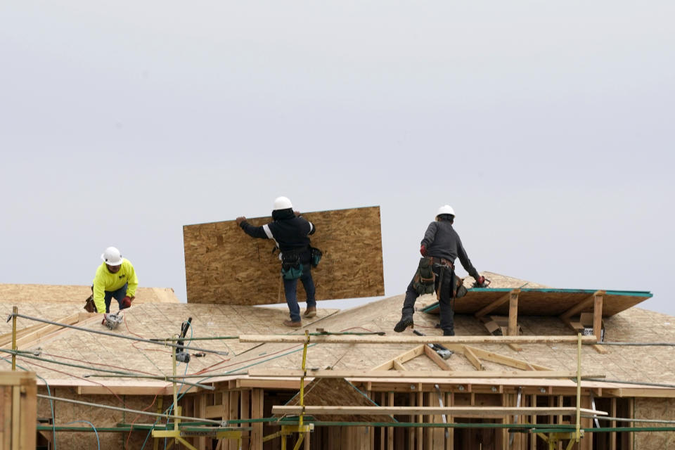 FILE - Work is done on a house under construction in Sacramento, Calif., on Feb. 11, 2021. A plan released by the California Air Resources Board on Tuesday, May 10, 2022, suggests California require all new homes built starting 2026 to have electric appliances including heaters and stoves. (AP Photo/Rich Pedroncelli, File)