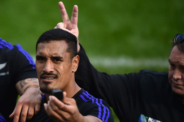 New Zealand's flanker Jerome Kaino makes a selfie as head coach Steve Hansen gestures behind him, at the end of the captain's run, at Saint James' Park Stadium in Newcastle-upon-Tyne, on October 8, 2015