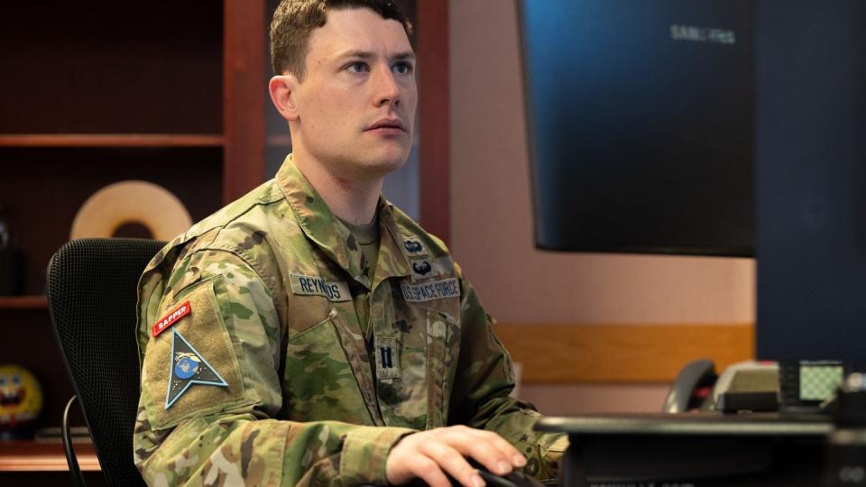 U.S. Space Force Capt. Daniel C. Reynolds works at a desk at Peterson Space Force Base, Colorado, April 22, 2022. (Ethan Johnson / Space Force)