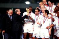 FIFA President Joseph Sepp Blatter presents France captain Marcel Desailly with the FIFA Confederations Cup trophy after defeating Japan 1-0. (Photo by Matthew Ashton/EMPICS via Getty Images)