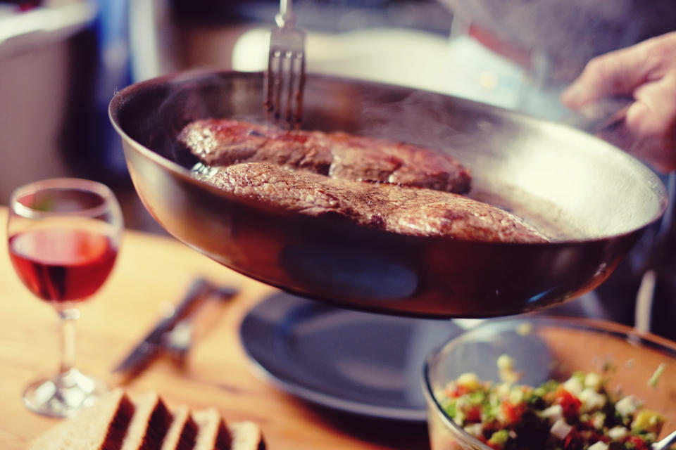 Serving steak from a skillet.