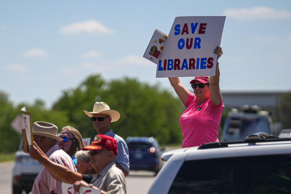 Llano resident Emily Decker protests outside a Llano County Commissioners Court meeting Thursday. The Commissioners Court met to consider closing the Llano County library system rather than comply with a judge's order to return several banned books to the libraries. "Books. That's why we're here. Books," Decker said.