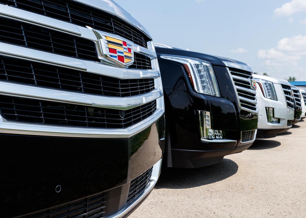 A close up of logo on car at a Cadillac dealership.