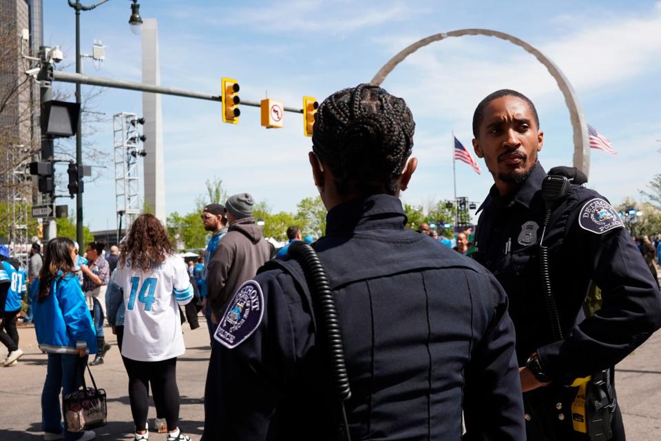 Detroit Police officers stand at an entrance during the NFL Draft Experience at Hart Plaza in downtown Detroit on Friday, April 26, 2024.