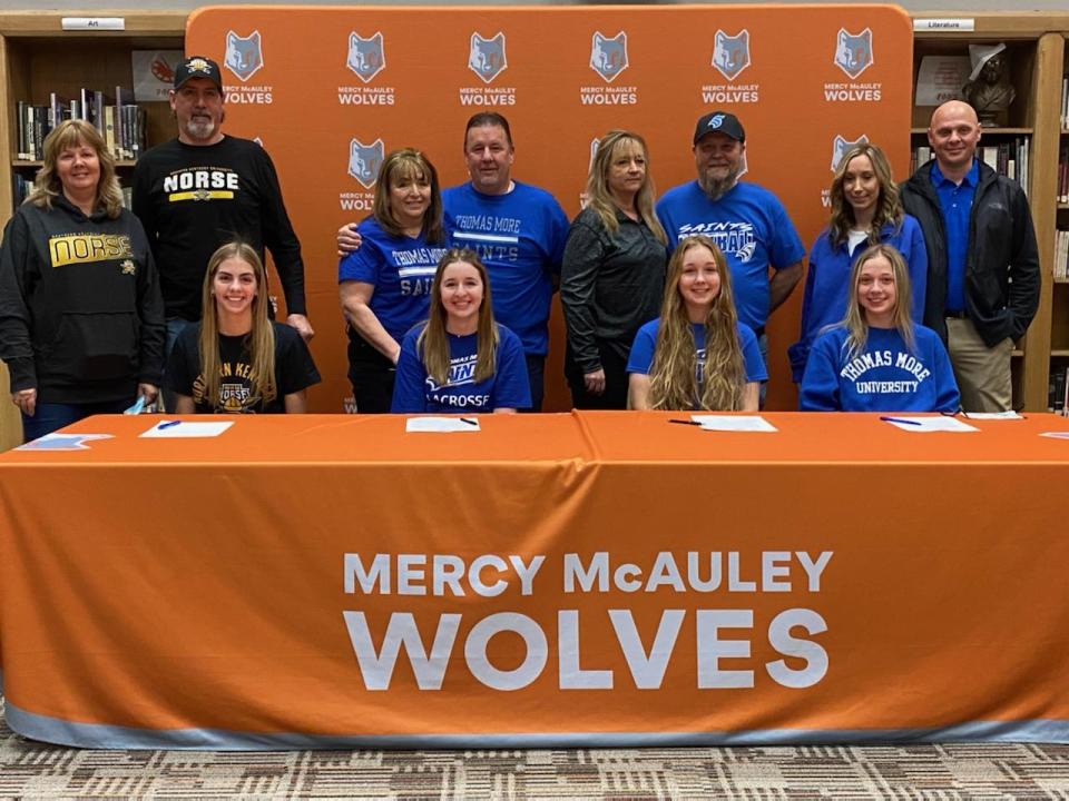 Mercy McAuley athletes signing to play college sports Feb. 2 were, from left: Raelyn Sanders, Northern Kentucky University volleyball with parents, Sandy and Woody; Megan Pierani, Thomas More University lacrosse with parents, Michele and Randall; Madison Henry, Thomas More University softball with parents, Taunya and Kenneth; and Ashton Elbe, Thomas More University softball with parents, Tara and Brian.