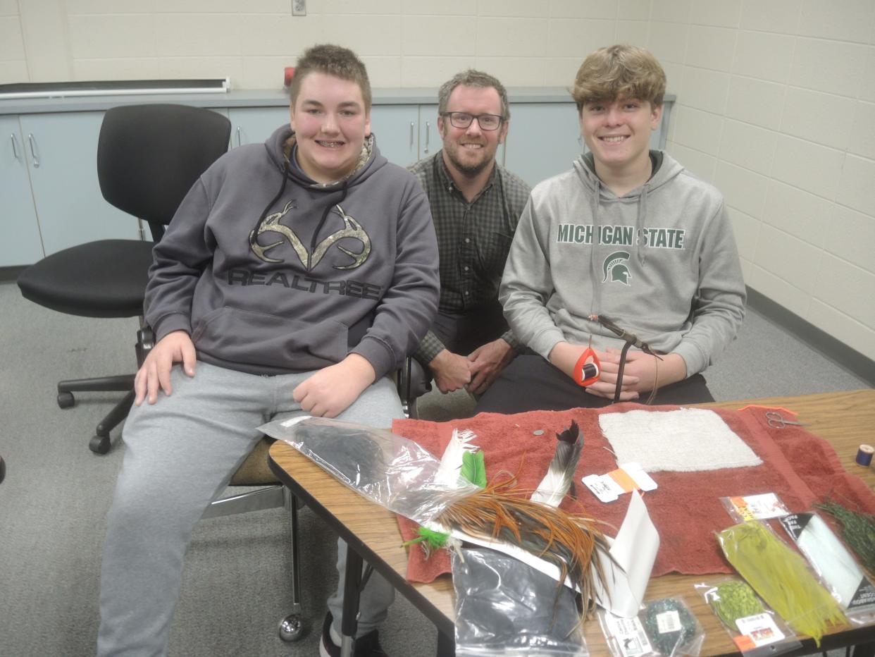 From left Leeland Fox, Daniel Stoffer and Luke Somerville are shown with "Woolly Buggers," an artificial fly commonly categorized as a wet fly or streamer. Stoffer serves as the faculty adviser for the Gaylord High School fishing club which was organized by sophomores Fox and Somerville last spring.