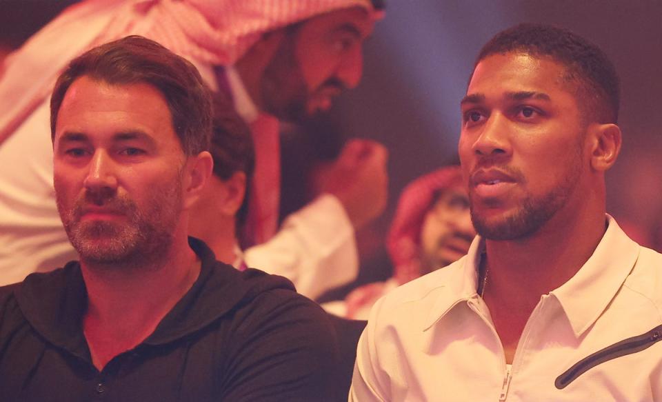 Hearn (left) with Joshua, watching Fury vs Usyk from ringside (Getty Images)