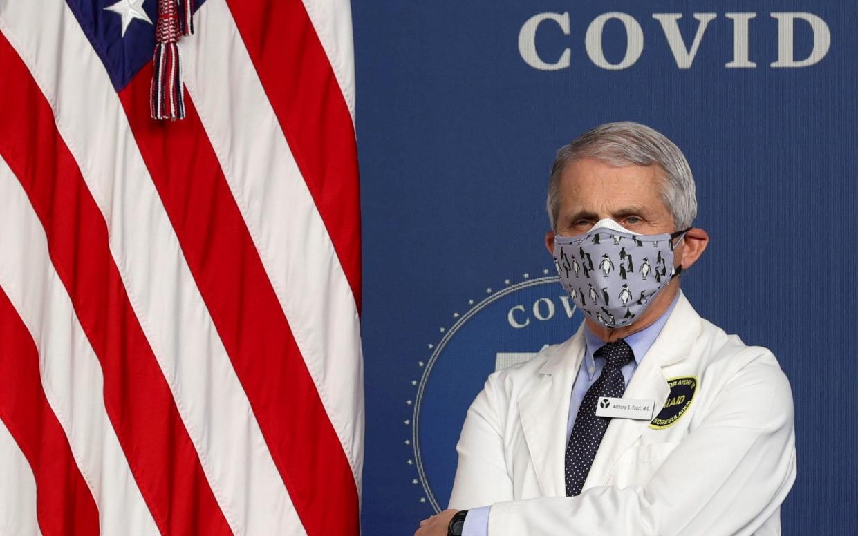 FILE PHOTO: National Institute of Allergy and Infectious Diseases Director Dr. Anthony Fauci stands by during an event to commemorate the 50 millionth coronavirus disease (COVID-19) vaccination in the South Court Auditorium at the White House in Washington, U.S., February 25, 2021. REUTERS/Jonathan Ernst