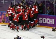 Canada's players celebrate after defeating Team USA to win their women's ice hockey gold medal game at the Sochi 2014 Winter Olympic Games February 20, 2014. REUTERS/Jim Young