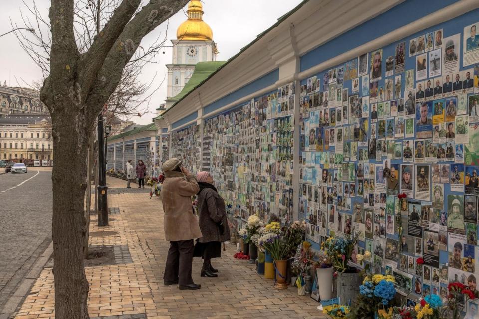 PHOTO: A woman looks at a photo of her son Tymofii Boyko, a Ukrainian soldier who was killed fighting Russian troops, on the 'Wall of Remembrance of the Fallen for Ukraine' in downtown Kyiv, on February 23, 2024. (Roman Pilipey/AFP via Getty Images)