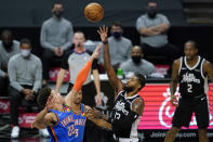 Los Angeles Clippers guard Paul George (13) takes a shot against Oklahoma City Thunder forward Isaiah Roby (22) during the second quarter of an NBA basketball game Sunday, Jan. 24, 2021, in Los Angeles. (AP Photo/Ashley Landis)