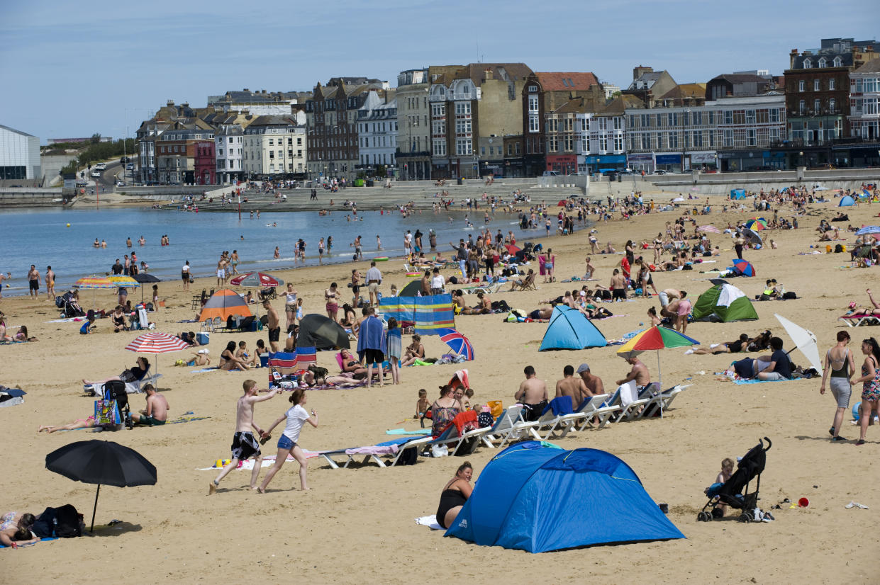 MARGATE, KENT, UNITED KINGDOM - 2020/05/26: People and families on the beach sunbathing, swimming, playing and generally enjoying the fine sunshine in one of England's oldest seaside resorts, pretty much ignoring the UK Government's advice to obey social distancing guidelines so as to prevent the spread of the Covid-19 coronavirus. (Photo by Peter Charlesworth/LightRocket via Getty Images)