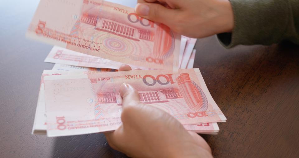 Woman counting RMB banknote