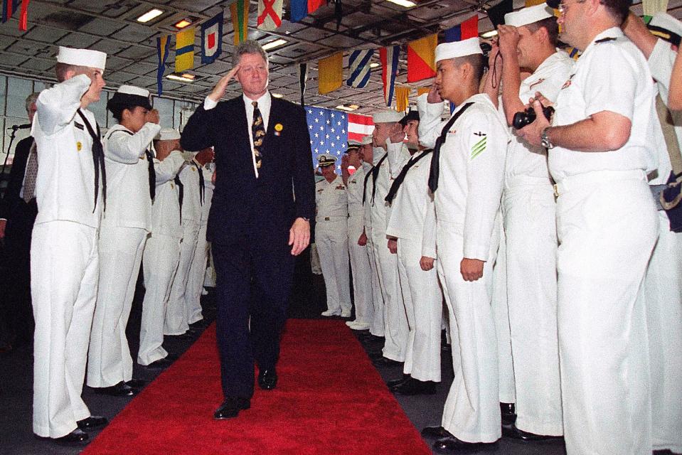 Bill Clinton salutes sailors aboard the USS Eisenhower