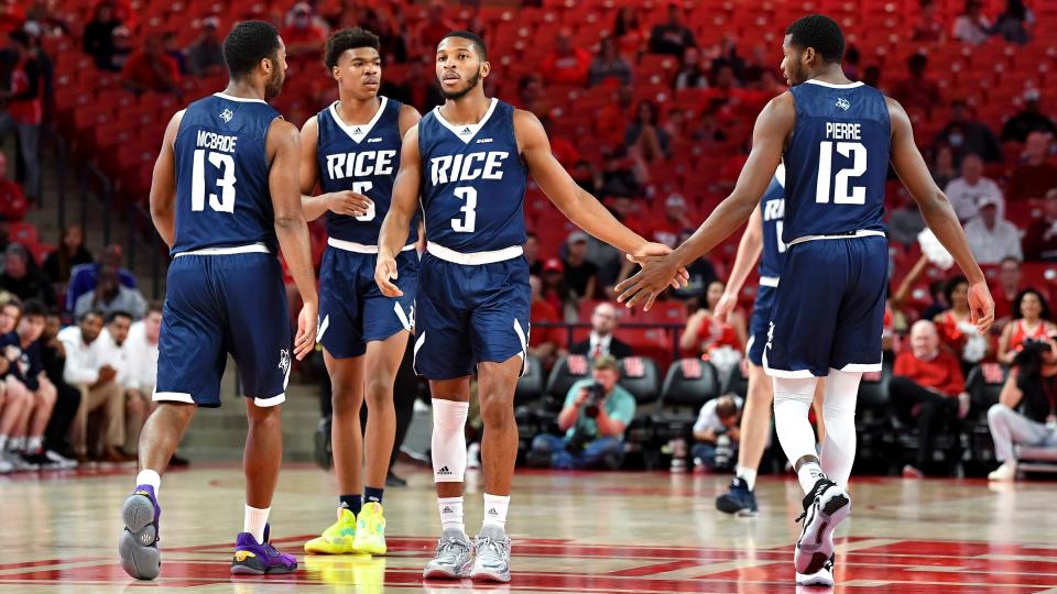 Former BC High teammates Carl Pierre (12) and  Travis Evee (3) have reunited on the campus of Temple University in Houston. They are shown here during a Nov. 12, 2021, regular season game between the Rice Owls and the University of Houston Cougars at the Fertitta Center in Houston.