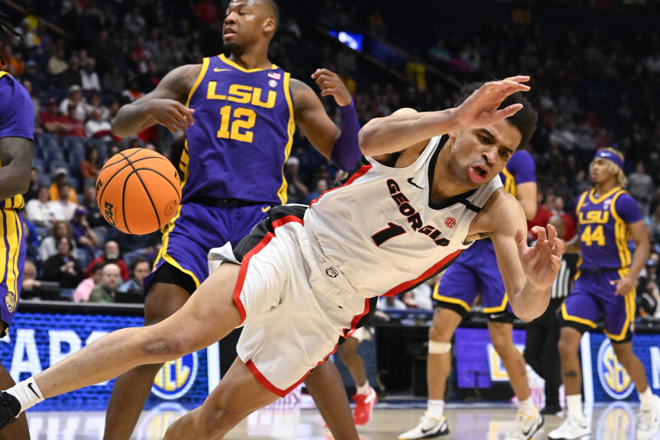 Georgia guard Jabri Abdur-Rahim (1) falls after a foul by LSU forward KJ Williams (12) during the second half of an NCAA college basketball game in the first round of the Southeastern Conference tournament, Wednesday, March 8, 2023, in Nashville, Tenn. LSU won 72-67. (AP Photo/John Amis)