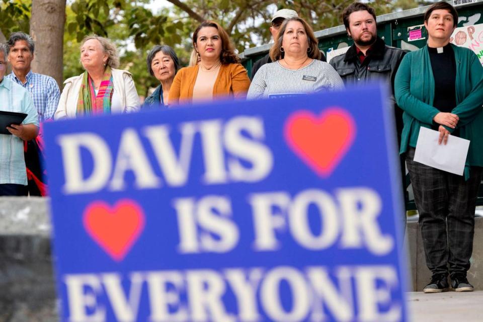 Speakers line up on stage during a rally at Davis’ Central Park Tuesday to support the LGBTQ community after recent bomb threats against the city’s schools and its main library.