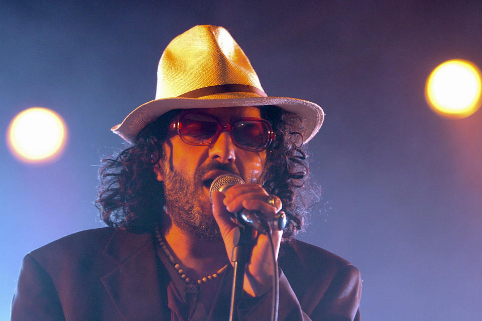 FILE - In this July 19, 2005 file photo, Algerian singer Rachid Taha sings on the main stage during the opening day of the Paleo Festival in Nyon, Switzerland. Rachid Taha, an Algerian singer who thrillingly blended Arabic music with rock and techno and at times wore blue contact lenses to protest anti-Arab prejudice in France, where he made his home, has died. He was 59. (Sandro Campardo, Keystone via AP, File)