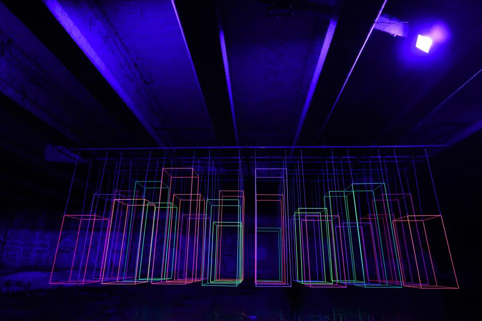 The "NeonCity" installation hangs under a bridge at the Waterloo Greenway Creek Show on Nov. 10.