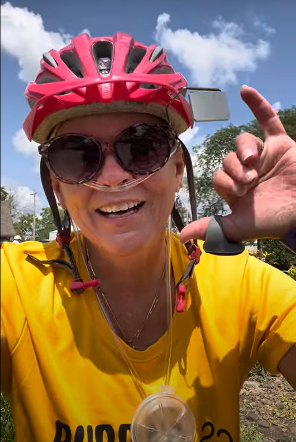 Barb Heenan gives a dispatch of RAGBRAI Day 1 to her Facebook followers. Heenan, who has limited systemic scleroderma, is riding RAGBRAI while wearing an oxygen tank.