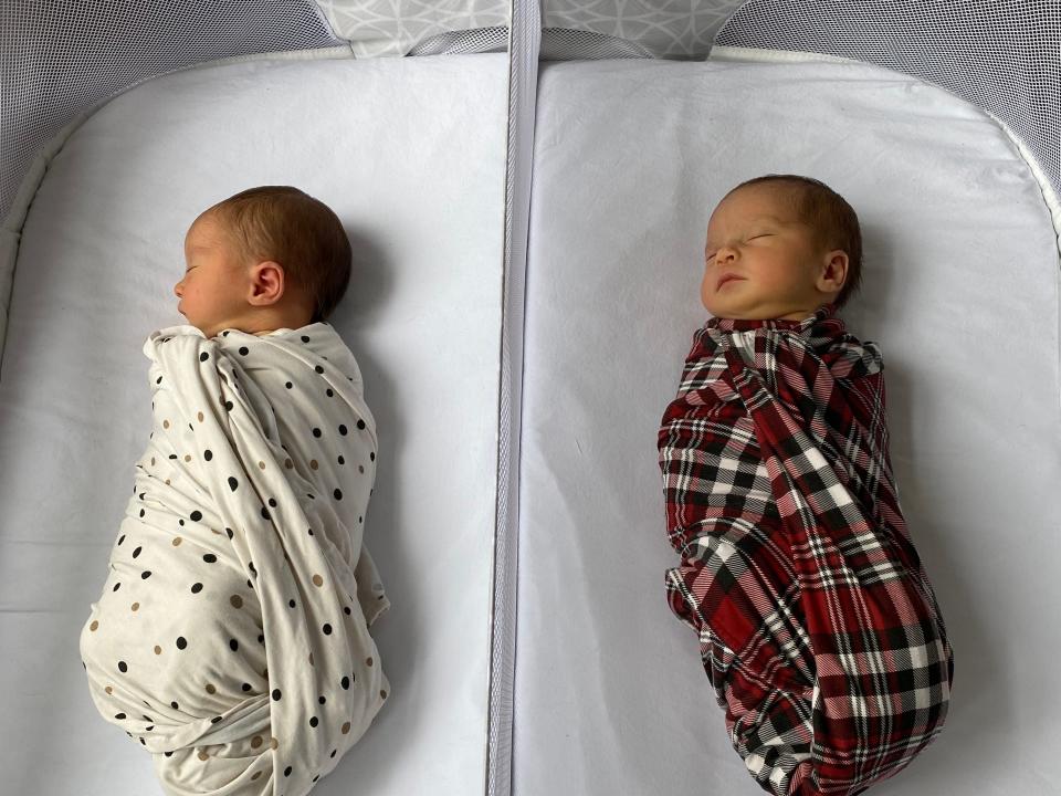 Twins sleeping in bassinet