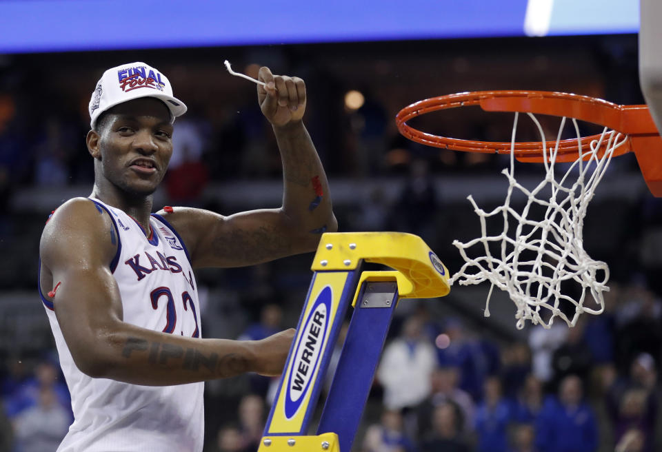 Kansas’ Silvio De Sousa celebrates by cutting down the net after defeating Duke in a 2018 regional final game. (AP)