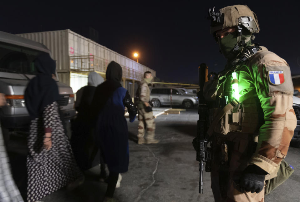 This photo provided Tuesday Aug.24, 2021 by the French Army shows a French soldier at Kabul airport, Afghanistan, Friday Aug. 20, 2021. France has evacuated over 1,000 Afghans from Kabul over the past week, including a large majority of Afghans who worked with the French government or French groups in the country. (Etat-Major des Armees via AP)