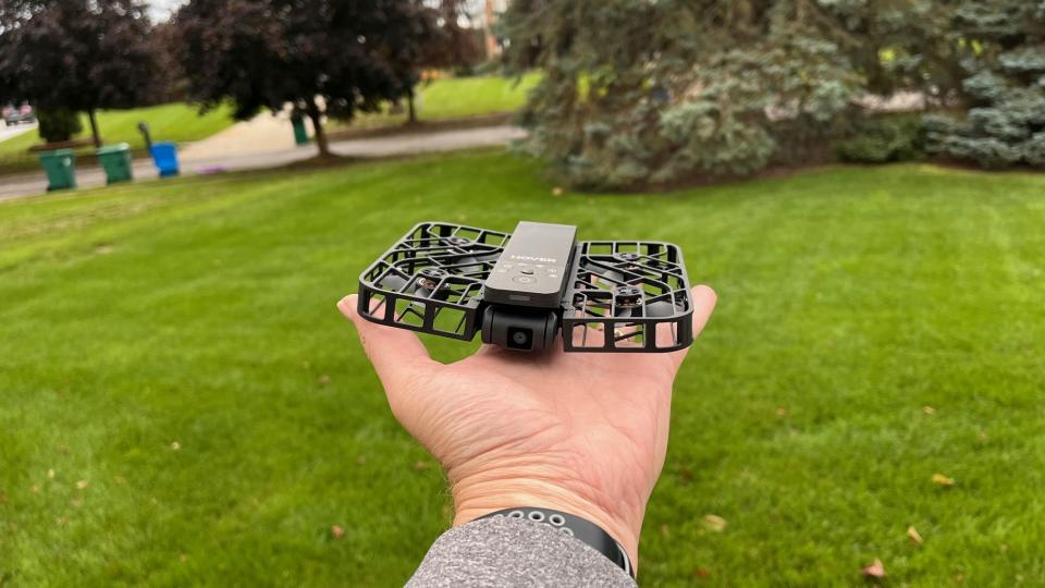 The HoverAir X1 shown on an outstretched palm, ready for takeoff.