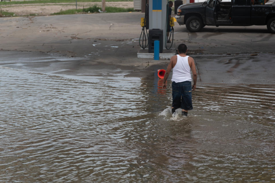 A local resident trudges through flood waters to get to his truck  Friday on Paramount Blvd. in Amarillo,