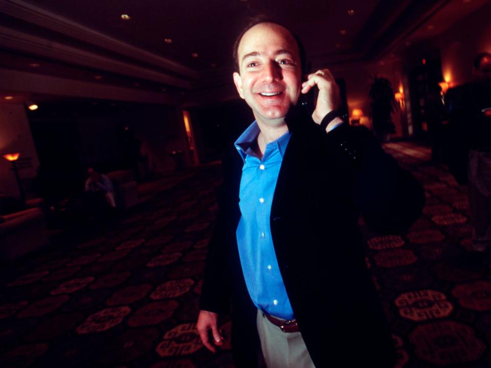 Jeff Bezos talking on the phone and smiling