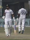 India's Shreyas Iyer, left, and Ravichandaran Ashwin, run between the wickets during the day four of their first test cricket match with New Zealand in Kanpur, India, Sunday, Nov. 28, 2021. (AP Photo/Altaf Qadri)