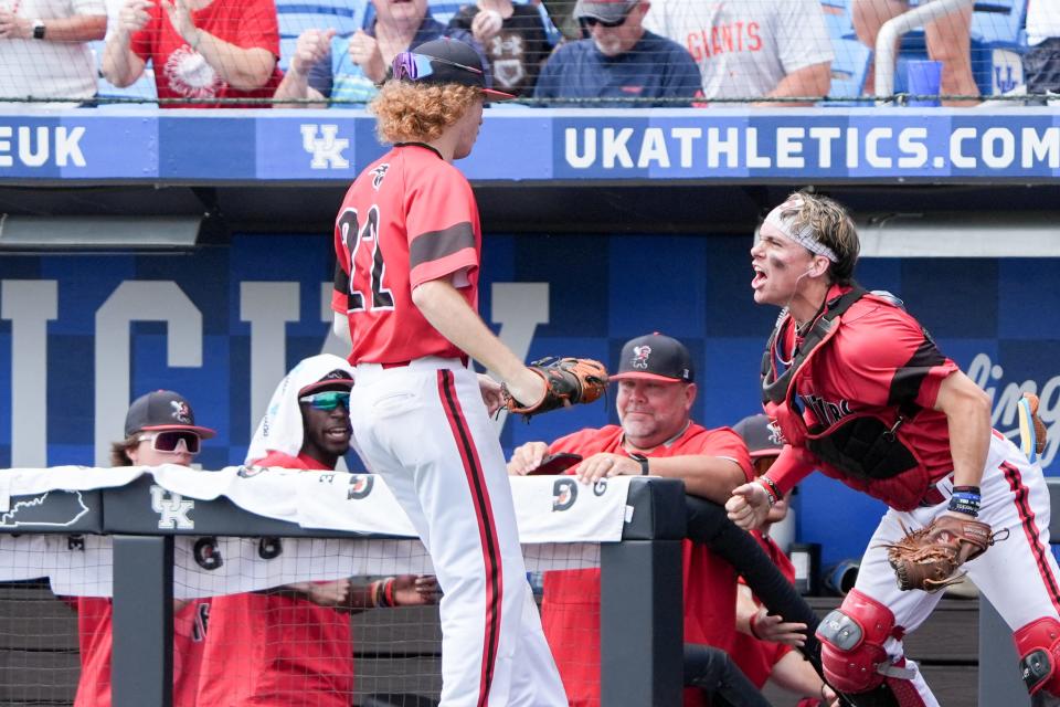 Pleasure Ridge Park's Hank Burns (1) celebrates with Cooper Brukhardt (22) after making a diving catch during their game against Trinity on Friday, June 14, 2024 in Lexington, Ky. at Kentucky Proud Park for the state baseball semifinals.