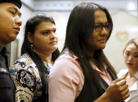 Transgender women leave the Federal Court after it dismissed an attempt by three transgenders to declare unconstitutional a ban on cross-dressing in a Malaysian state in Putrajaya, Malaysia, October 8, 2015. REUTERS/Olivia Harris