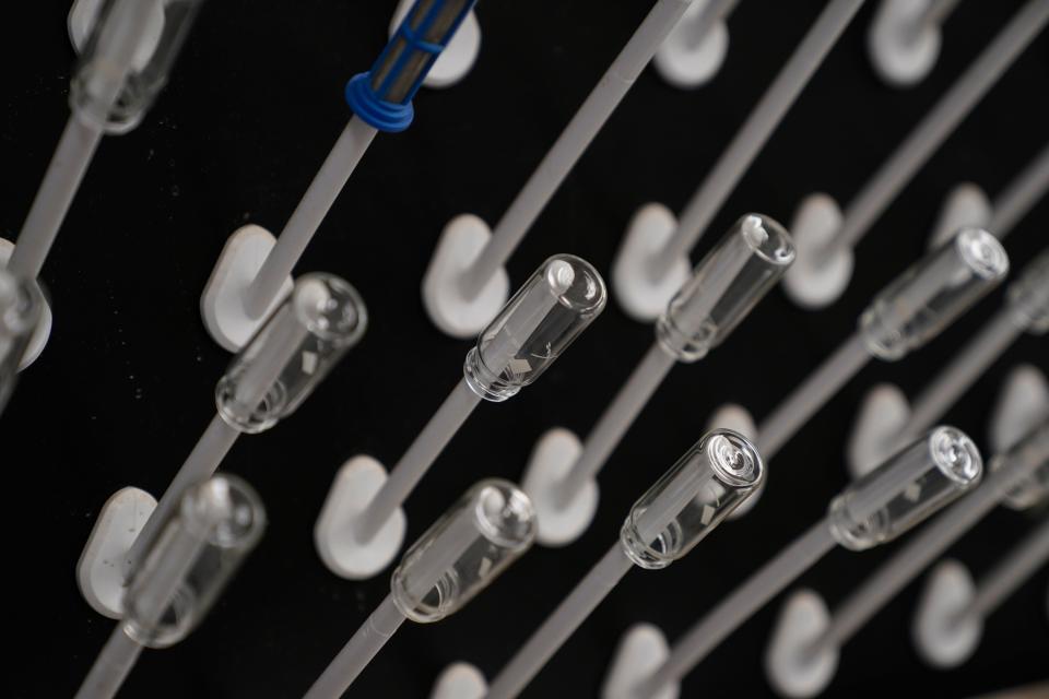Glass vials hang on a rack inside a lab, Tuesday, Feb. 14, 2023, at the U.S. Environmental Protection Agency Center For Environmental Solutions and Emergency Response in Cincinnati.