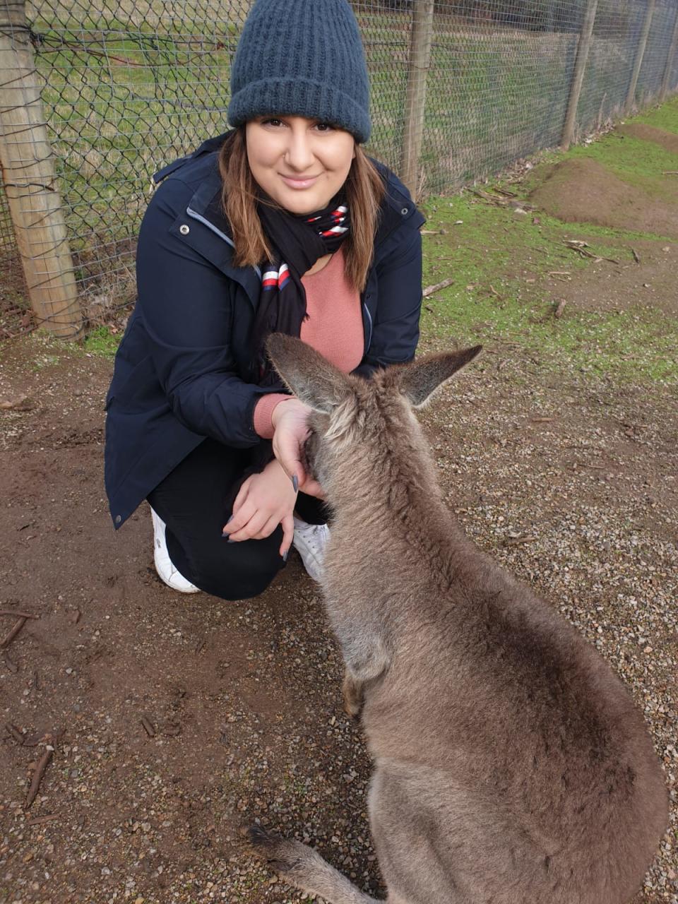 The 25-year-old is seen feeding a kangaroo.