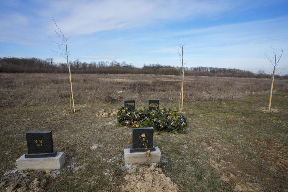 The gravestones under which unidentified remains of 41 people retrieved from the river since 2017, are seen at the cemetery in Bijeljina, eastern Bosnia, Sunday, Feb. 4, 2024. In several cities along this river between Bosnia and Serbia, simple, durable gravestones now mark the final resting places of dozens of refugees and migrants who drowned in the area while trying to reach Western Europe. (AP Photo/Darko Vojinovic)