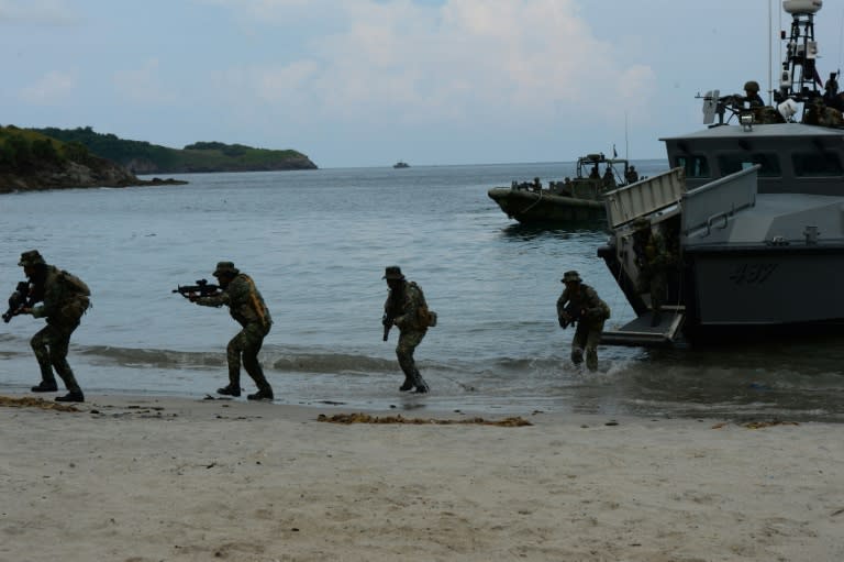 Philippine marines disembark from a naval boat as they simulate a hostage rescue mission, at a marine training base in Cavite province, west of Manila, on September 24, 2015