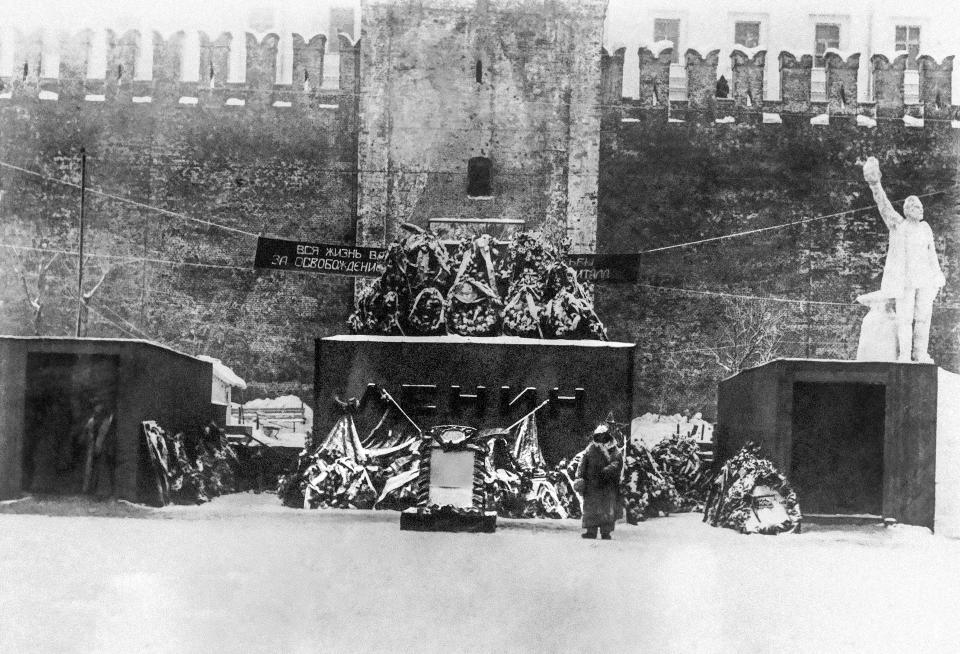 FILE - The first mausoleum of Vladimir Lenin, the founder of the Soviet Union, who died on Jan. 21, 1924, is seen in Red Square next to the Kremlin Wall in Moscow, Russia, on Feb. 25, 1924. Not long after his death that year, a popular poet proclaimed words that thrilled the grieving country: "Lenin lived, Lenin lives, Lenin will live." But Lenin remains mostly an afterthought in modern Russia. (AP Photo, File)