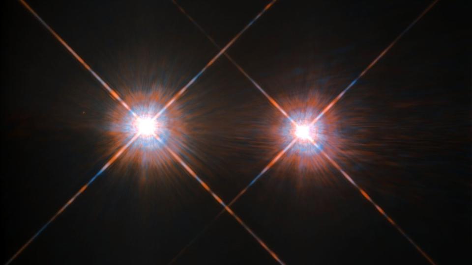 Binary stars of the nearby Alpha Centauri system, as seen by NASA's Hubble Space Telescope.  On the left is Alpha Centauri A, a sun-like G-type star.  On the right is Alpha Centauri B, a slightly cooler K-type star.