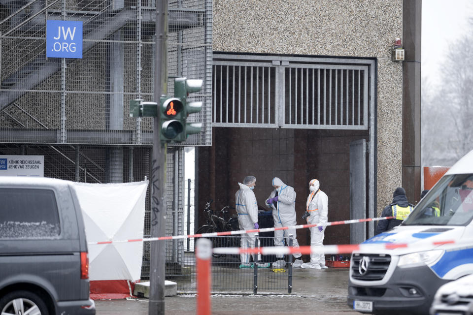 Forensic expert stand at a Jehovah's Witness building in Hamburg, Germany Friday, March 10, 2023. Shots were fired inside the building used by Jehovah's Witnesses in the northern German city of Hamburg on Thursday evening, with multiple people killed and wounded, police said. (AP Photo/Markus Schreiber)