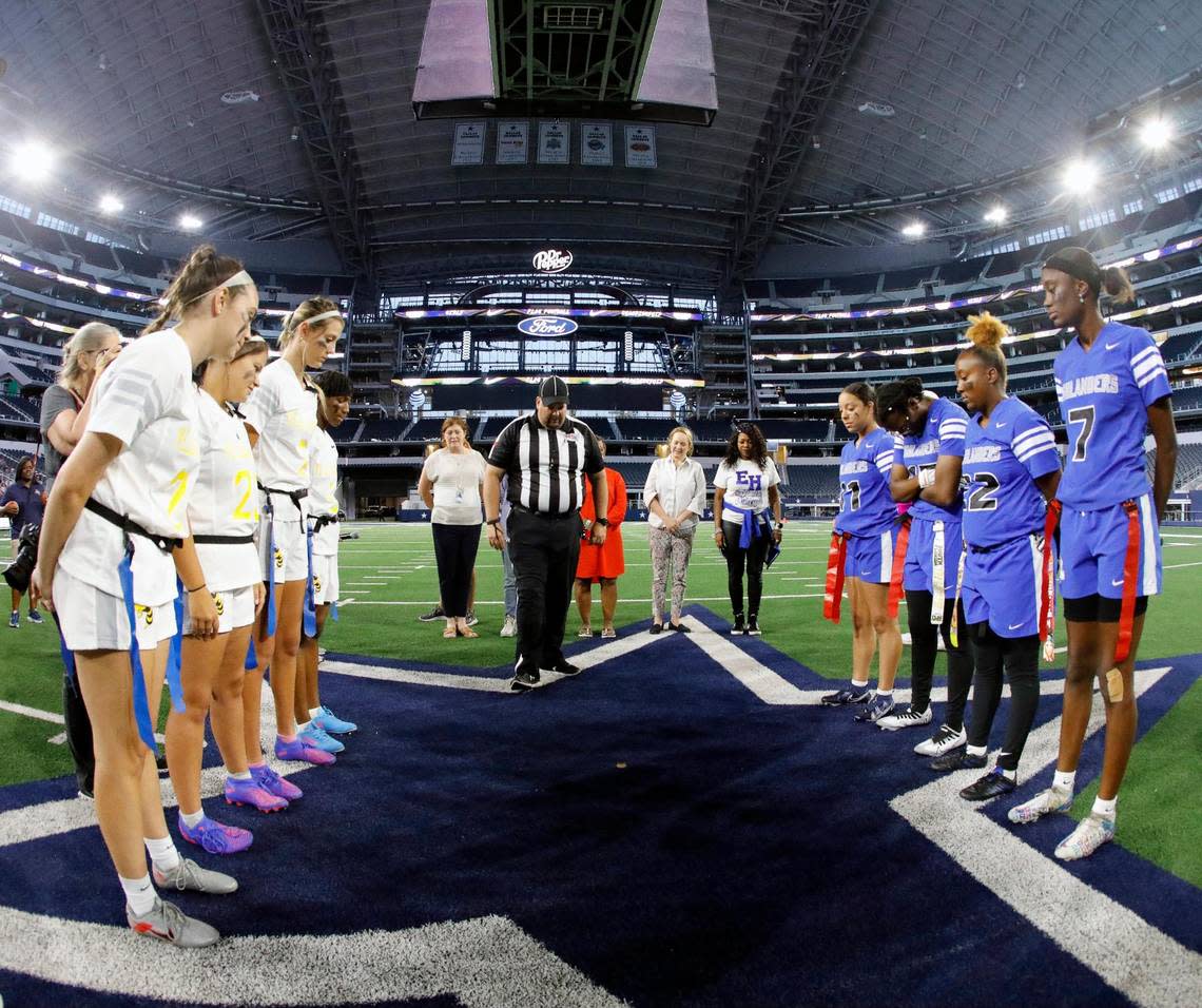 Arlington Heights and Eastern Hills players watch as an official tosses the game coin to start the Fort Worth ISD championship flag football game at ATT Stadium in Arlington, Texas, Wednesday, May 18, 2022. Arlington Heights defeated Eastern Hills . (Special to the Star-Telegram Bob Booth)