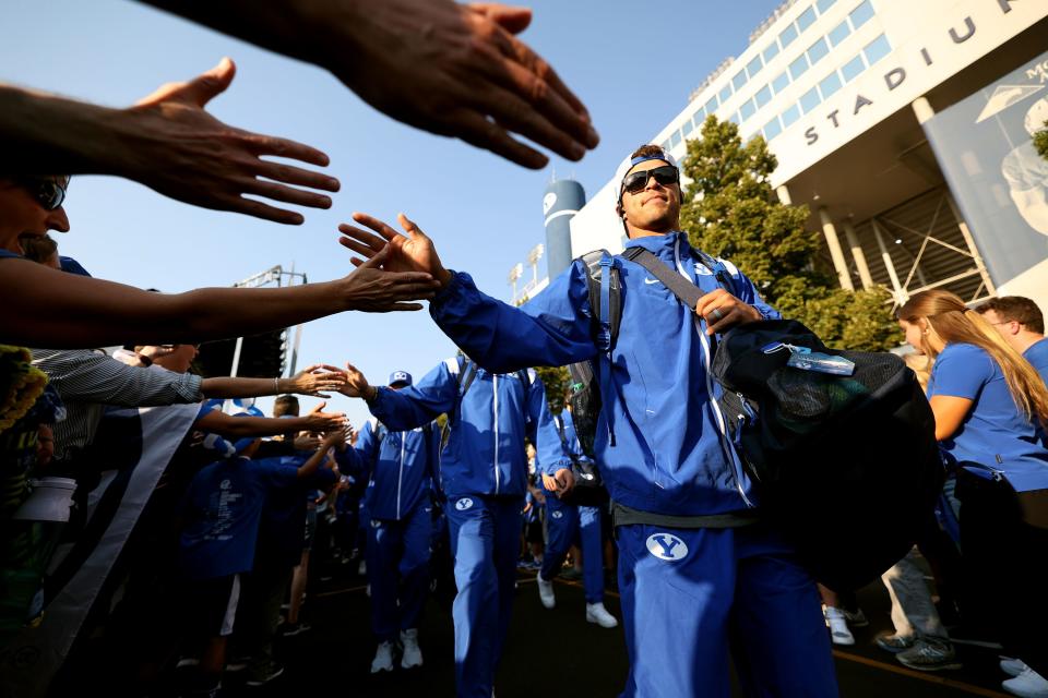 Brigham Young Cougars quarterback Jaren Hall (3) and his teammates greet fans as they arrive at the stadium as BYU and Baylor prepare to play at LaVell Edwards Stadium in Provo on Saturday, Sept. 10, 2022.